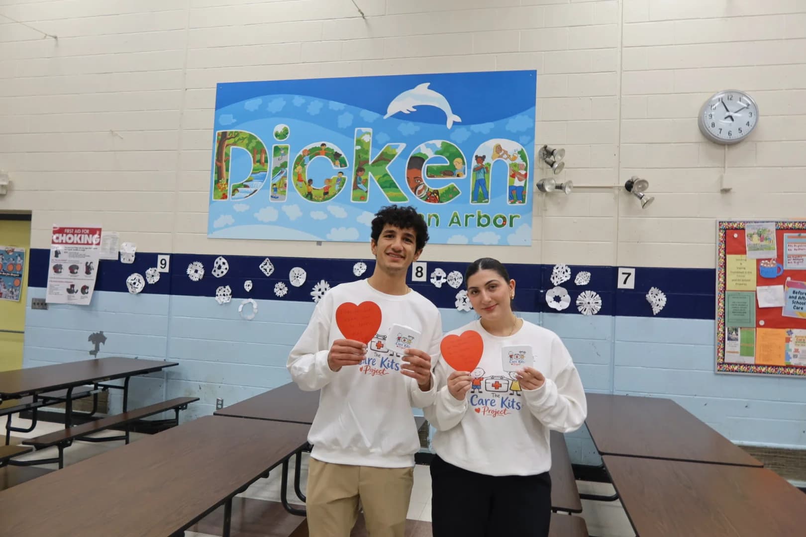 Alexander and Lilyana posing with heart notes and stickers at Dicken Elementary